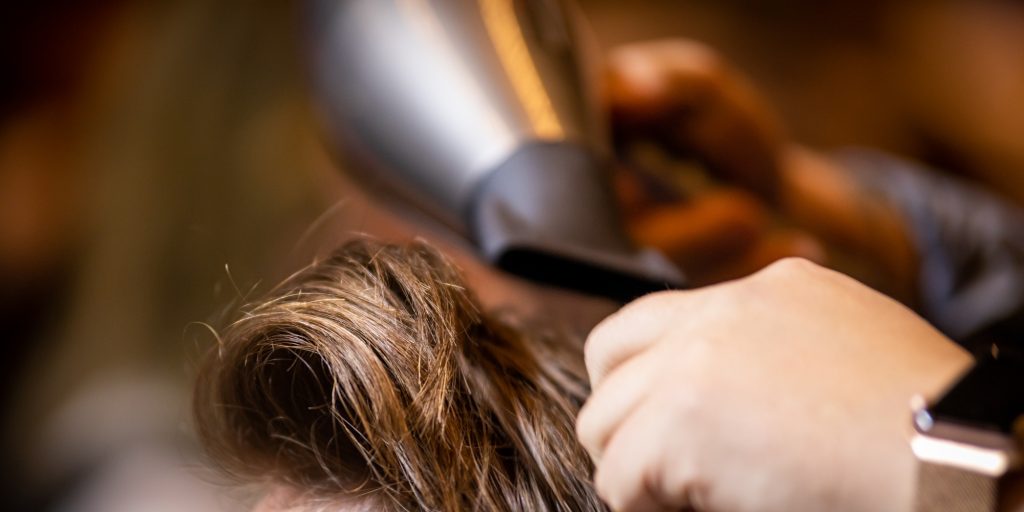 Hands of barber making haircut to young man in barbershop - FR Hair & Beauty| Pennant Hills Hands of barber making haircut to young man in barbershop